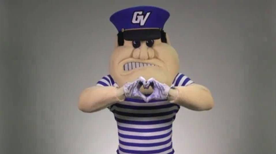 Louie the Laker making a heart with his hands